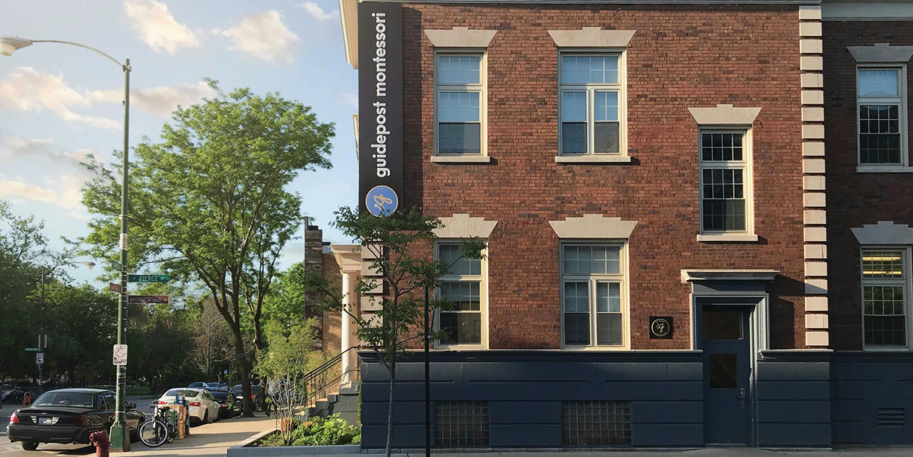 street-facing view of Guidepost Montessori at Wicker Park school building with Guidepost Montessori branded sign on brick façade