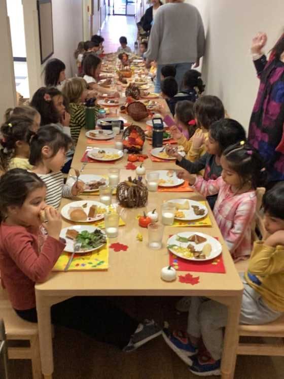 Kindergarten children having a meal together.