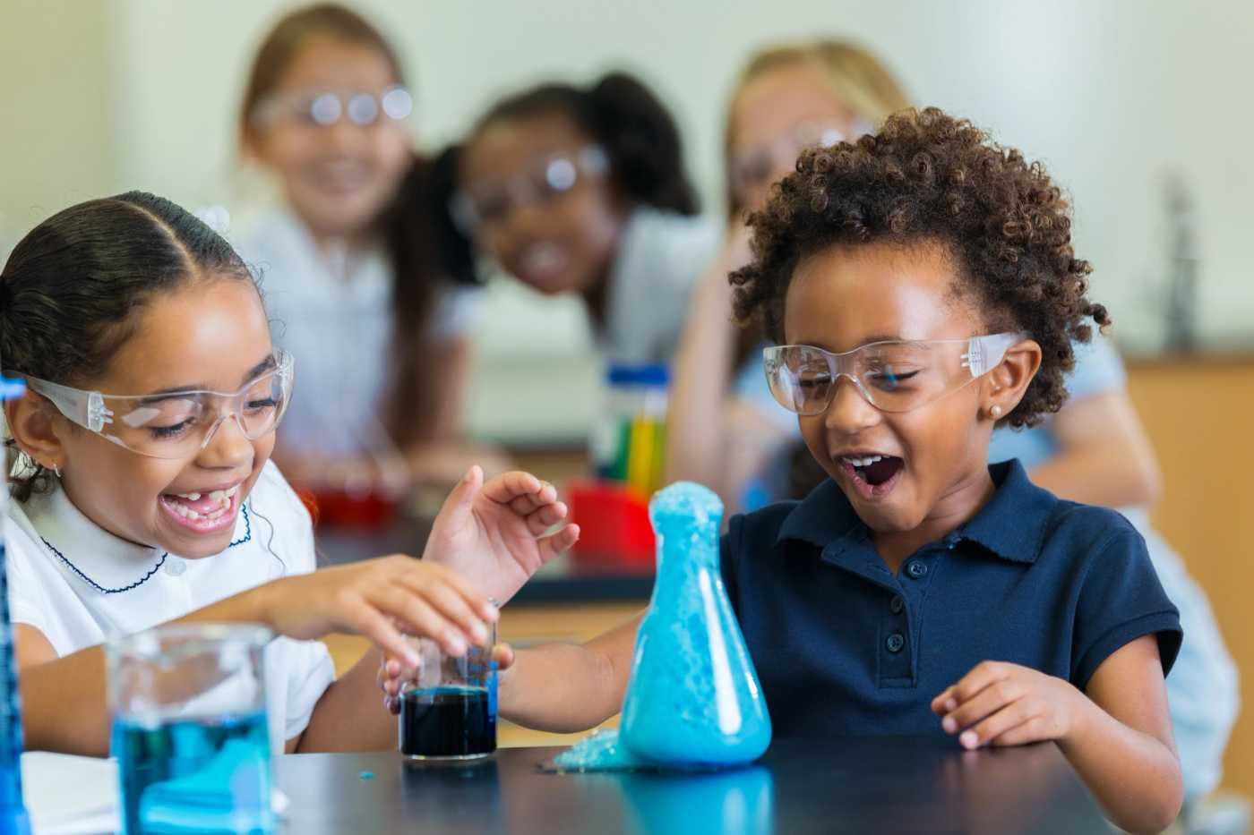 children performing beaker experiment in birmingham montessori kindergarten science class 