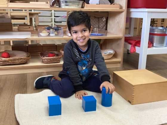 Preschool student enjoying blocks in a prepared environment.