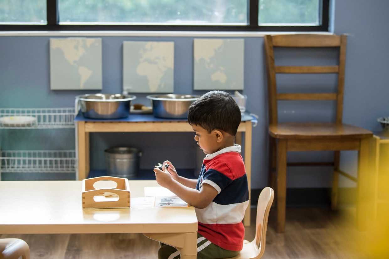 guidepost montessori student sitting at table