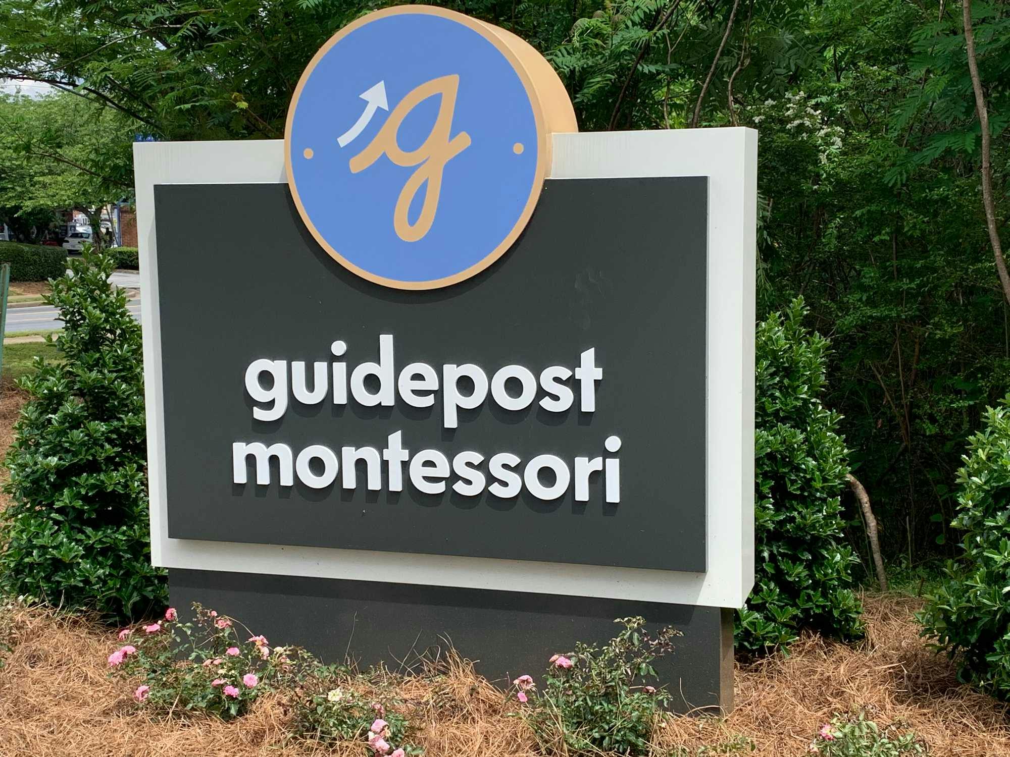 A branded sign reading Guidepost Montessori which is stationed at our Marietta, Georgia campus.